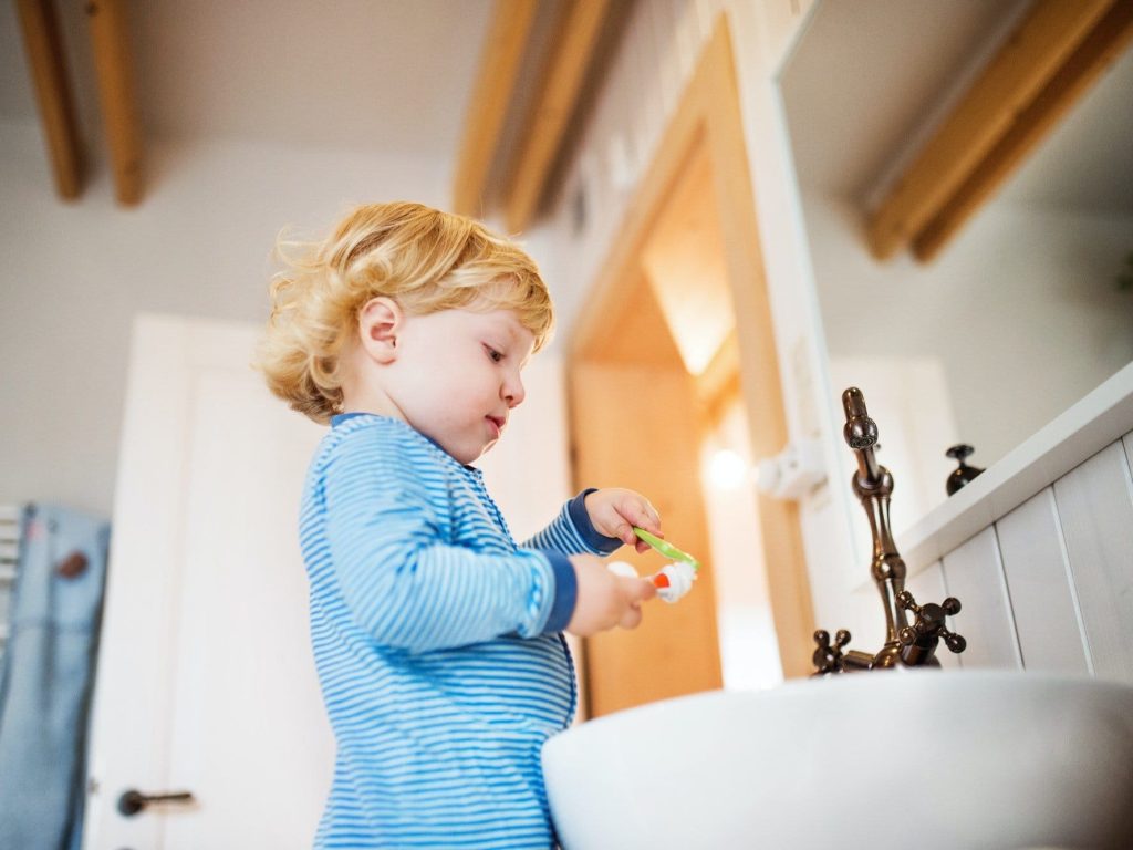 Cute-toddler-boy-brushing-his-teeth-in-the-bathroom-. Jpg
